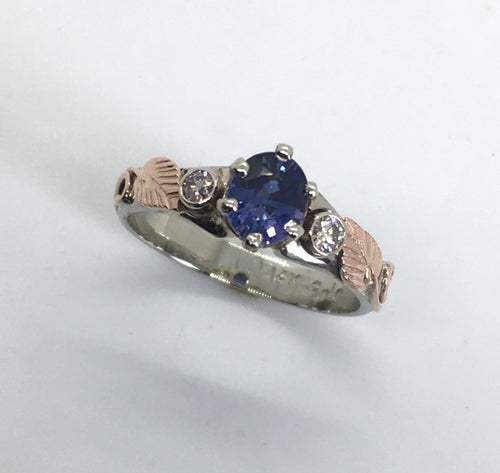 rare color change sapphire in white gold with rose gold leaves and pink diamonds