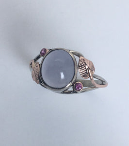 sensuous cabachonl blue chalcedony bezel set with pink sapphires in rose and white 14K gold ring with leaf pattern
