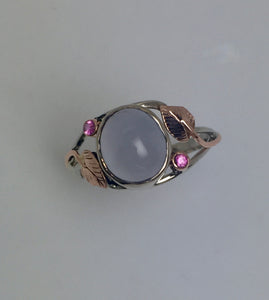 sensuous oval blue chalcedony bezel set with bright pink sapphires in open-work rose and white 14Kg ring with leaf pattern