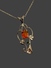 Load image into Gallery viewer, beautful oval orange Mexiican fire opal with green Tsavorite garnet in 14Kg pendant with leaves, vines and a lilly