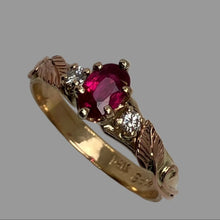 Load image into Gallery viewer, Ring with oval-shaped ruby, yellow gold prongs and rose gold details, featuring diamonds on the sides