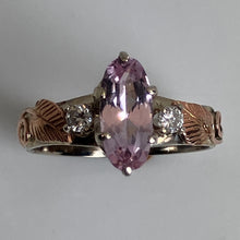 Load image into Gallery viewer, A rose and white gold ring featuring a marquise-cut pink topaz center stone, flanked by two small round-diamonds. a rose gold side details, set against a plain light gray