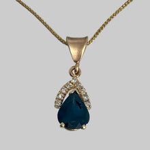 Load image into Gallery viewer, Large pear shaped dark blue sapphire necklace with 9 diamonds above the point on a solid gold bail.