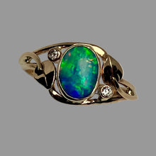 Load image into Gallery viewer, 14K yellow gold ring featuring a large oval cabochon opal with vibrant green and blue play-of-color, accented by two small round diamonds on the shoulders,