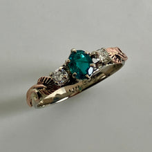 Load image into Gallery viewer, 14K white gold band with rose gold leaves and vines, a very rare oval
grandidierite trichroic gem and a pair of upcycled diamonds., all set in prong settings.