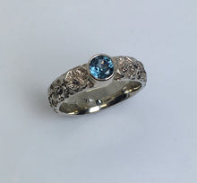 Load image into Gallery viewer, 14K white gold band dogwood flowers all around and a beautiful bezel set montana sapphire