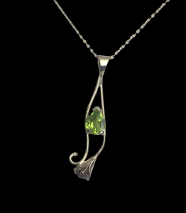 Bright green teardrop shape peridot set in a gold calla lily design, on a square cable chain,  lobster claw clasp.