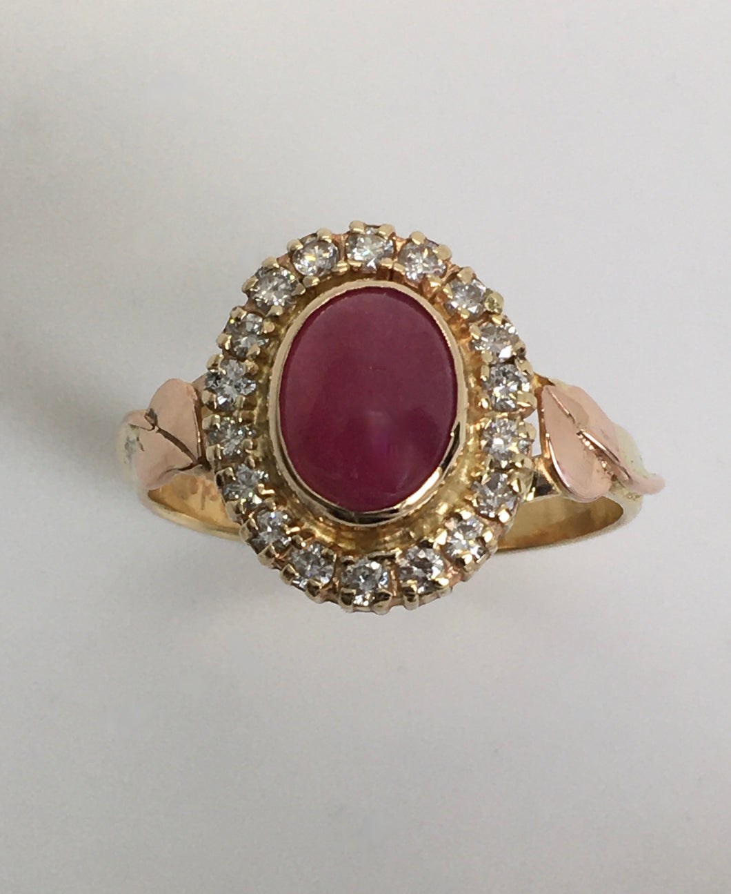 luminous oval ruby in a halo of diamonds ring