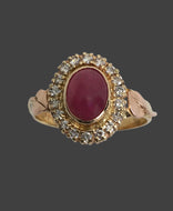 luminous oval ruby in a halo of diamonds ring