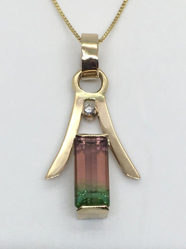 brilliant pink and green tourmaline under a gold pagoda roof , end-only bezel settings