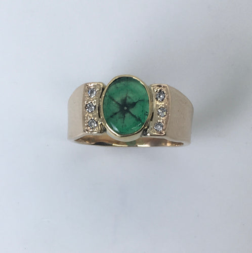 oval cabochon emerald ring has black spokes from the center, 6 diamonds on the sides