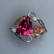 stunning pink/red gem in a freeform white/rose gold ring