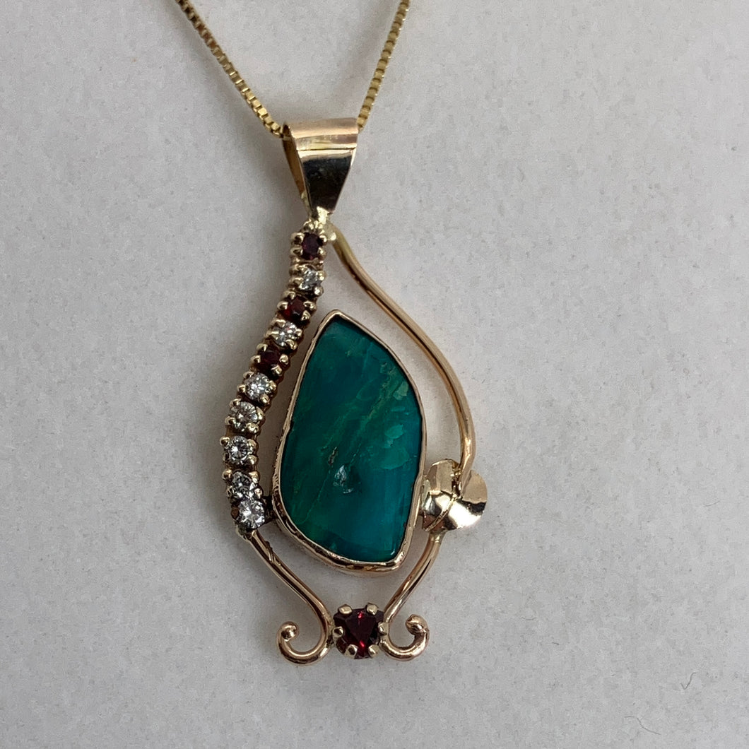 mystical blue/green Pilot Mt. Turquoise in an earthy diamond and garnet setting