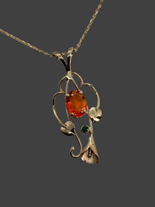 beautful oval orange Mexiican fire opal with green Tsavorite garnet in 14Kg pendant with leaves, vines and a lilly