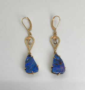 Blue/purple triangular Boulder Opals in handmade prong settings dangling from leaf and vine motif openwork, each set with 1 small diamond, on European earn wires