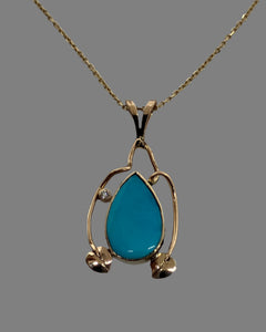 virtually flawless robins egg blue natural sleeping beauty turquoise  surrounded by 14k gold leaves and vines