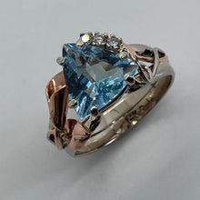 Load image into Gallery viewer, artist design cut extra fine aquamarine in a heavy mixed gold setting with diamonds, leaves and a flower 
