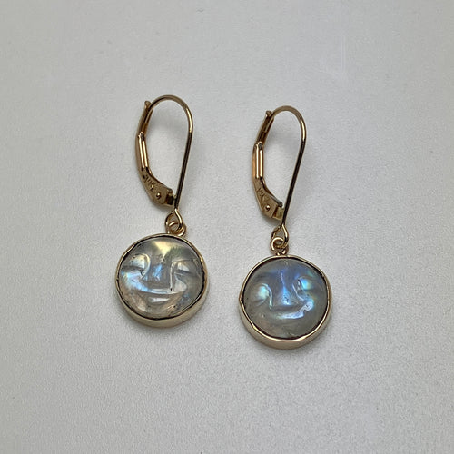 Pair of gold earrings with round carved moonstones 