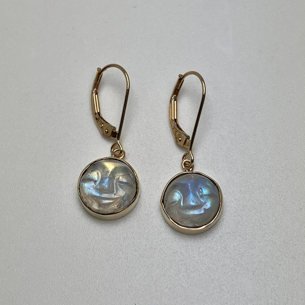 Pair of gold earrings with round carved moonstones 