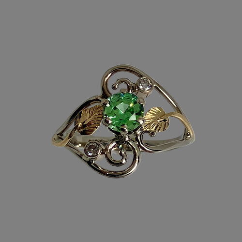 round lime  green gemstone, 2 diamonds, 14K white gold band with 18K yellow gold accents 