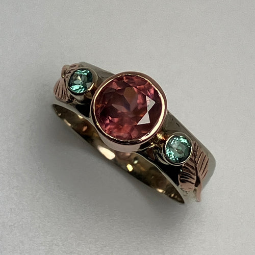 ring with a faceted  pink Zircon and 2  green Parieba Tourmalines, in bezels, all 14K white and rose gold