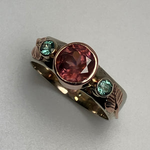 ring with a faceted  pink Zircon and 2  green Parieba Tourmalines, in bezels, all 14K white and rose gold