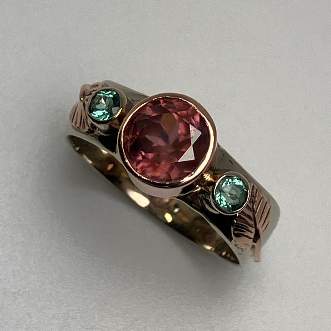 ring with a faceted  pink Zircon and 2  green Parieba Tourmalines, in bezels, all 14K white and rose gold