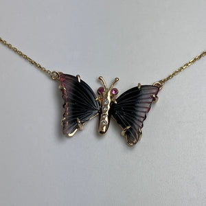 butterfly shaped necklace with dark green tourmaline wings with pink tips, pink sapphire eyes  and upcycled diamond body in 14K gold