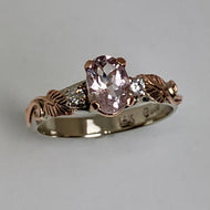 white gold ring with a pink morganite, 2 diamonds and rose gold leaves