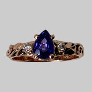 Rose gold ring with pear shape purple sapphire, diamonds, leaves and vines