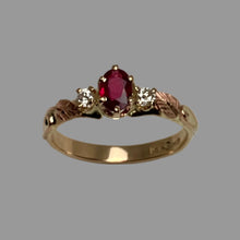 Load image into Gallery viewer, Gold ring with a red gemstone and smaller diamonds on a gray background
