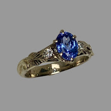 Load image into Gallery viewer, white gold ring with an oval Tanzanite and smaller diamondswith leaves and vines
