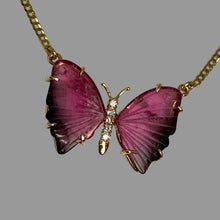 Load image into Gallery viewer, Butterfly-shaped pink and black tourmaline pendant on a gold chain.
