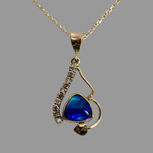 Load image into Gallery viewer, 14K yellow gold necklace featuring a bezel set triangle blue/green/purple crystal opal, 10 small upcycled diamonds, swerving vine with an ivy leaf

