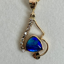 Load image into Gallery viewer, 14K yellow gold pendant with a vibrant blue/gree/purple iridescent triangle opal, a curved bar of 9 pave set recycled diamonds and a leaf and vine.
