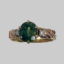 Load image into Gallery viewer, Broad oval natural gereen sapphire on a yellow gold band with rose gold leaves and a pair of recycled diamonds.
