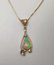 Load image into Gallery viewer, A free form solid Australian Opal with a mosaic of colors surrounded by a handmade 14Kgold lily and leaf.
