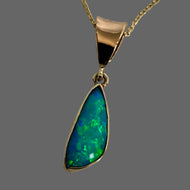 Freeform trtiangle blue/green opal in a 14K yellow gold bale setting