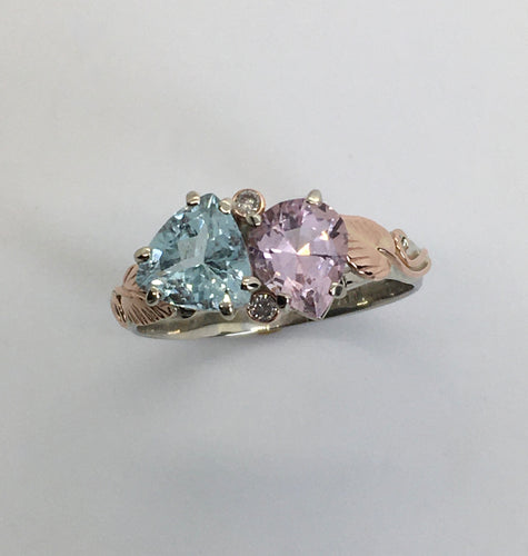 Sparkling Aquamarine next to gorgeous Morganite with rose gold leaves on white gold band
