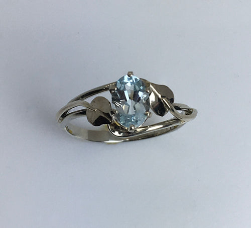 shiny soft blue faceted Aquamarine in white gold ring with custom leaf and vine motif
