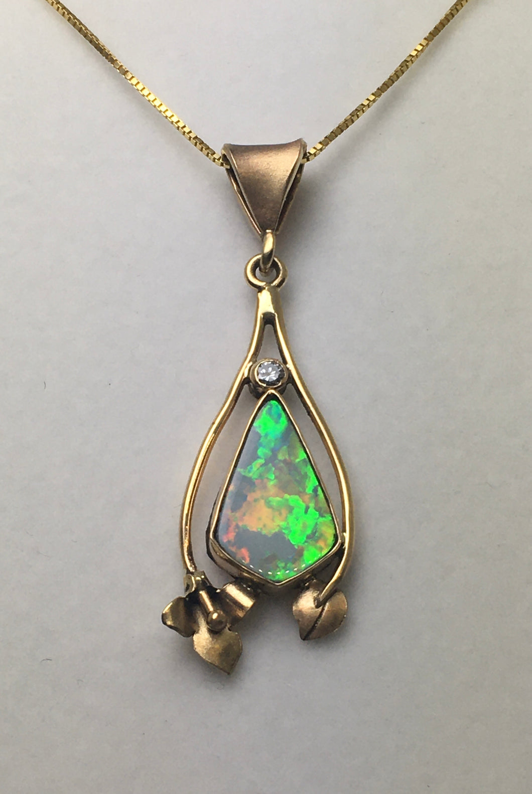 brilliant free form diamond pendant with large flashes of color
