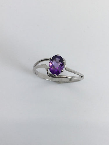 faceted oval amethyst in simple white gold ring